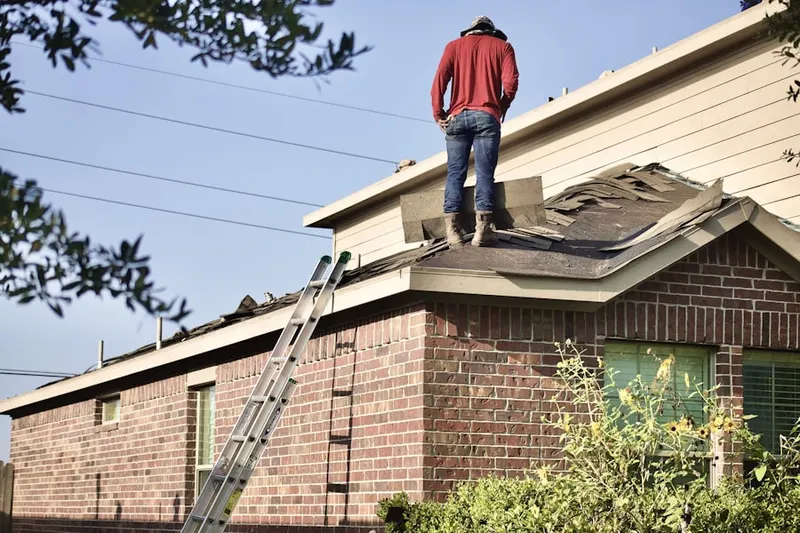 Professional roofer working on a residential roof in Pecan Plantation
